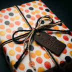 Festive balloon birthday wrapping paper by Wrapped Studios with rustic twine and a No Peeking tag.