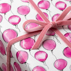 Gift wrapped in pink balloon birthday wrapping paper with velvet ribbon.