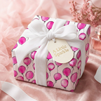 Pink balloon pattern wrapping paper with white velvet ribbon and gift tag.