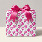 Hot pink balloon pattern gift wrap with satin ribbon. Birthday wrapping paper from Wrapped Studios.