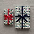 Vintage balloon birthday wrapping paper on gifts with red and navy velvet ribbons by Wrapped Studios.