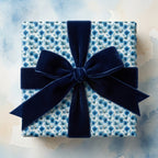 Luxury blue floral wrapping paper with a navy velvet bow by Wrapped Studios.