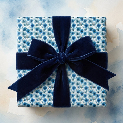 Luxury blue floral wrapping paper with a navy velvet bow by Wrapped Studios.