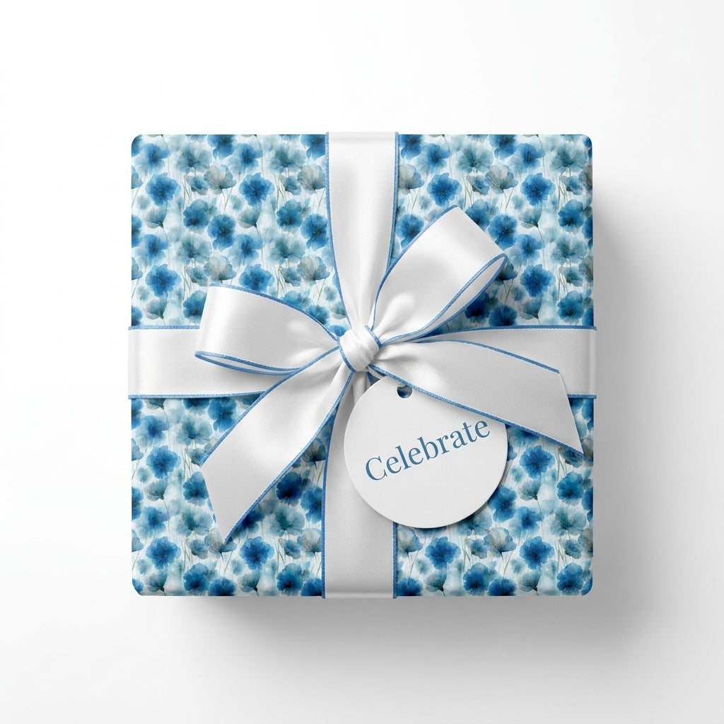 Blue floral wrapping paper with white ribbon and celebrate tag, elegant gift wrap by Wrapped Studios.