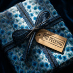 Vintage blue floral wrapping paper with a burlap ribbon and No Peeking tag by Wrapped Studios.