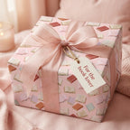 Pink book wrapping paper by Wrapped Studios with a sheer bow and "For the book lover" gift tag.