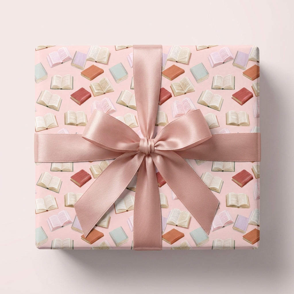 Pink book pattern wrapping paper with satin ribbon bow by Wrapped Studios, aesthetic gift wrap for book lovers.