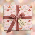 Book lover gift wrap on pink wrapping paper with a dusty rose velvet bow by Wrapped Studios.