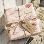 Book lovers wrapping paper by Wrapped Studios, tied with rustic twine and a kraft gift tag.