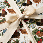 Farmhouse chicken wrapping paper tied with a cream cotton bow by Wrapped Studios.