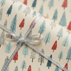 Elegant Christmas gift wrap with a whimsical blue and red tree pattern, tied with a shiny silver ribbon.