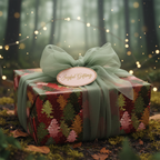 Christmas gift wrapped in elegant tree print paper with a sage green ribbon, presented outdoors.