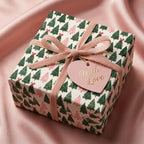 Luxury pink and green Christmas wrapping paper with a velvet ribbon and heart tag by Wrapped Studios.