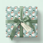 Watercolor snowman Christmas gift wrap with sage green satin ribbon by Wrapped Studios.