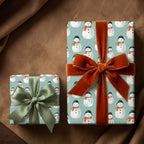 Snowman wrapping paper on Christmas gifts with luxury velvet ribbons by Wrapped Studios.
