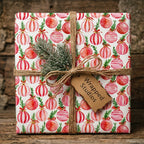 Festive watercolor ornament Christmas wrapping paper by Wrapped Studios, tied with rustic twine.