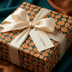 Coffee bean wrapping paper with a cream satin ribbon, unique gift wrap for coffee lovers by Wrapped Studios.