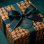 Coffee bean wrapping paper with luxury green ribbon and 'For You' tag by Wrapped Studios.