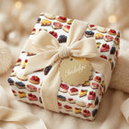 Whimsical "Indulge" gift with cake slice wrapping paper and velvet cream bow.