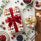 Gifts wrapped in dessert-themed wrapping paper with red and gold bows and bowls of fresh berries.