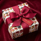 Wrapped Studios dessert print wrapping paper with maroon ribbon and "For You" tag.