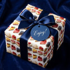 Wrapped gift featuring cake slice wrapping paper with blue satin ribbon. Enjoy! tag.