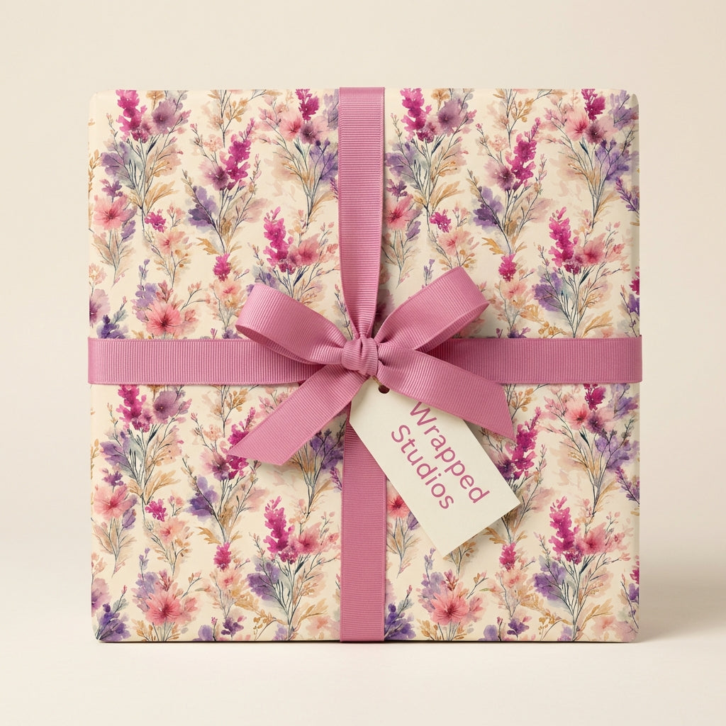 Square gift wrapped in floral wrapping paper with a pink ribbon and bow from Wrapped Studios.
