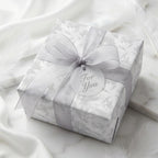 Luxury silver floral wrapping paper with grey ribbon and 'For You' gift tag by Wrapped Studios.