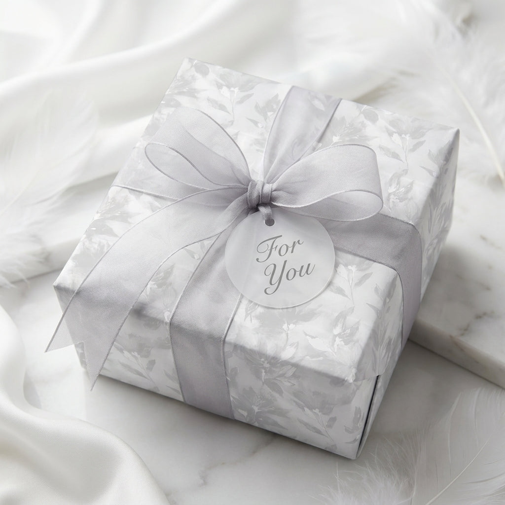 Luxury silver floral wrapping paper with grey ribbon and 'For You' gift tag by Wrapped Studios.