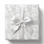 White floral wedding wrapping paper with a luxury satin bow by Wrapped Studios.