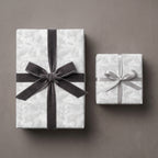 Elegant floral wrapping paper with grey velvet ribbon on gift boxes by Wrapped Studios.