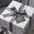 Luxury gray floral gift wrap with elegant ribbon and tag on a wedding gift box, by Wrapped Studios.