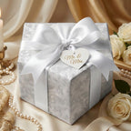 Elegant silver floral wedding wrapping paper with white satin bow and Mr. & Mrs. tag by Wrapped Studios.