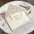 Elegant pink floral envelope liner and wedding invitation on marble by Wrapped Studios.