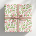 Watercolor pink floral wrapping paper with a dusty rose bow for elegant birthday gifts by Wrapped Studios.