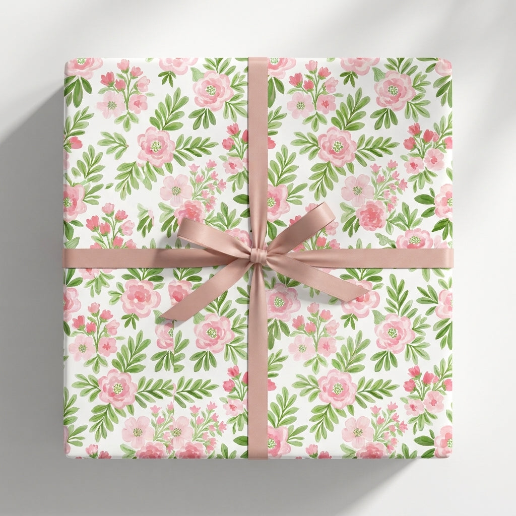 Watercolor pink floral wrapping paper with a dusty rose bow for elegant birthday gifts by Wrapped Studios.