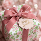 Pink floral birthday wrapping paper with a dusty rose velvet ribbon and tag by Wrapped Studios.