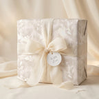 Luxury cream floral wedding wrapping paper with silk bow by Wrapped Studios.
