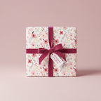 Elegant gift wrapped in pink floral wrapping paper, tied with a burgundy velvet ribbon.
