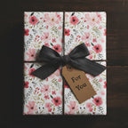 Elegant gift wrapped in floral wrapping paper with grey ribbon, perfect for a birthday present.