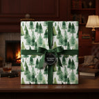 Elegant Christmas gift wrapped in watercolor fir tree paper with a dark green velvet ribbon.
