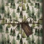 Christmas gift wrapped in rustic tree pattern paper with twine bow and tag.
