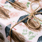 Floral graduation wrapping paper by Wrapped Studios with watercolor roses, graduate illustration, and twine bow.