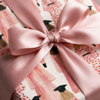 Pink graduation wrapping paper with watercolor graduate pattern and satin bow, Wrapped Studios.