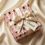 Pink graduation wrapping paper with illustrated graduates and a cream satin bow by Wrapped Studios.