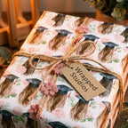 Floral graduation gift wrap with watercolor caps and a rustic twine bow, by Wrapped Studios.