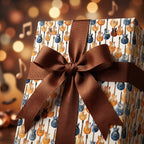 Guitar wrapping paper with electric guitars and a brown ribbon bow by Wrapped Studios.