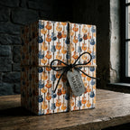 Electric guitar wrapping paper on a rustic gift box with a twine bow by Wrapped Studios.