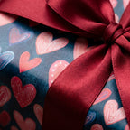 Valentine's Day heart wrapping paper with a luxury burgundy satin ribbon by Wrapped Studios.