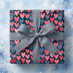 Valentine heart gift wrap with pink and red hearts on navy and a grey ribbon bow by Wrapped Studios.